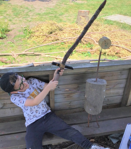 A child playing with a make-shift wooden sword