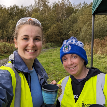 Two volunteers smiling