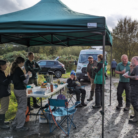 A group enjoying refreshments under a gazebo