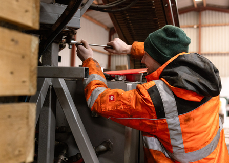 Cameron working on the bulrush harvester