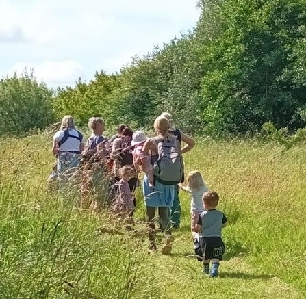 Parents and young children walking on a nature reserve