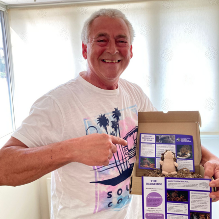 Stuart holding his hedgehog adopt a species pack