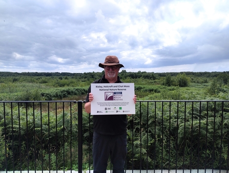 Senior Conservation Officer Martyn Walker with the National Nature Reserve plaque
