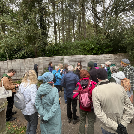 A group of members gathering around fungi expert
