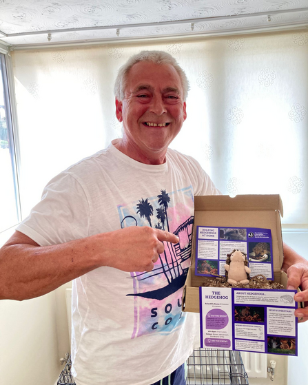 Stuart holding his hedgehog adopt a species pack