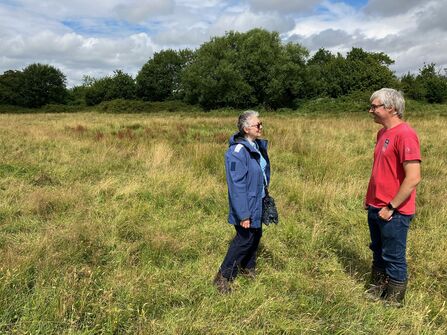 Two people stood in the fields at Cutacre nature reserve