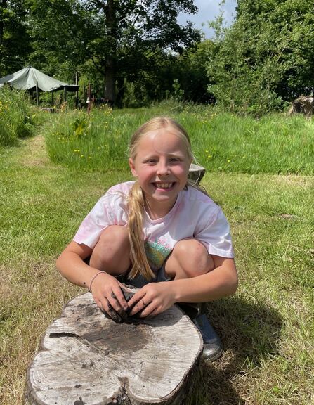 Happy Child playing in the mud at The Hive