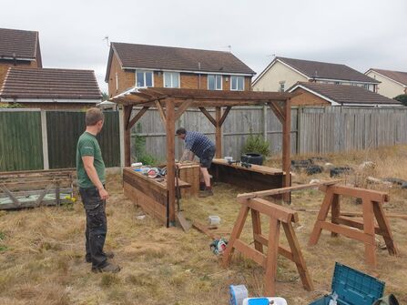 School grounds team installing a mud kitchen 