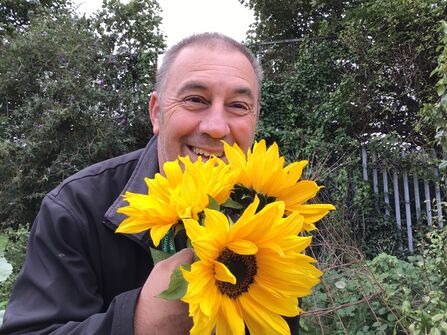 Carl Dutton holding sunflowers