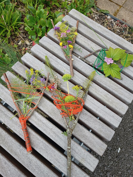 Environment art. Twigs wrapped with string and flowers.