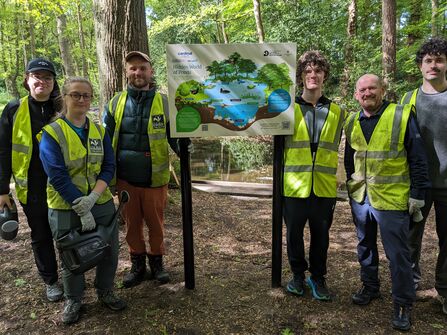 A group of people stood with the new interpretation boards