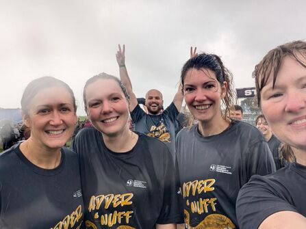 Four women wearing matching t-shirts