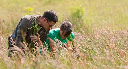 Two people conducting a grassland survey