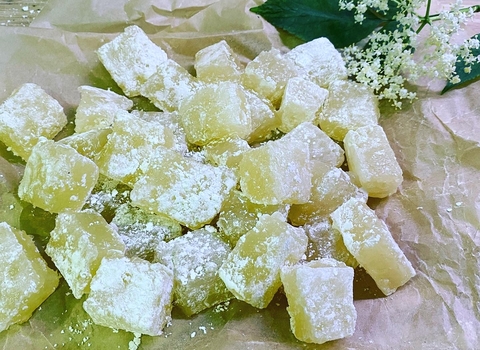 Cubes of elderflower Turkish delight on brown paper decorated with elderflowers