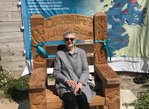 Hazel Ryan sitting on Lancashire Living Seas storytelling throne