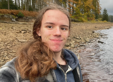 Euan at the edge of the water and shoreline.
