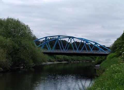 Blue bridge spanning the River Mersey