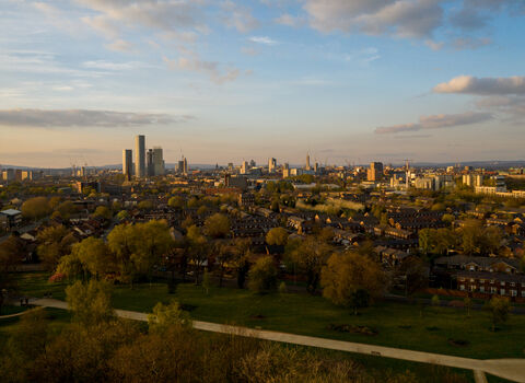 The Manchester Skyline with a park in the foreground by Nick Rodd