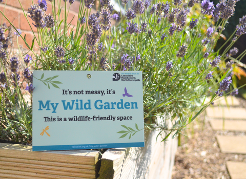 LWT's My Wild Garden plaque resting against a planter full of lavender