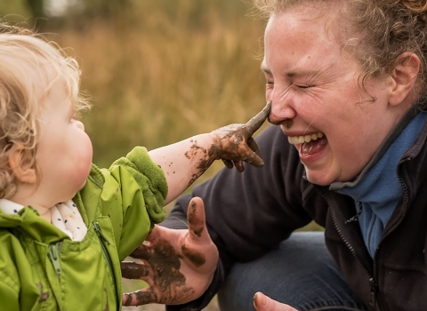 A family enjoying time outdoors in the mud