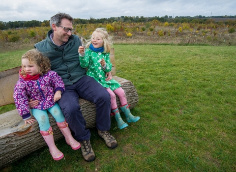 A family sitting on a bench and enjoying nature